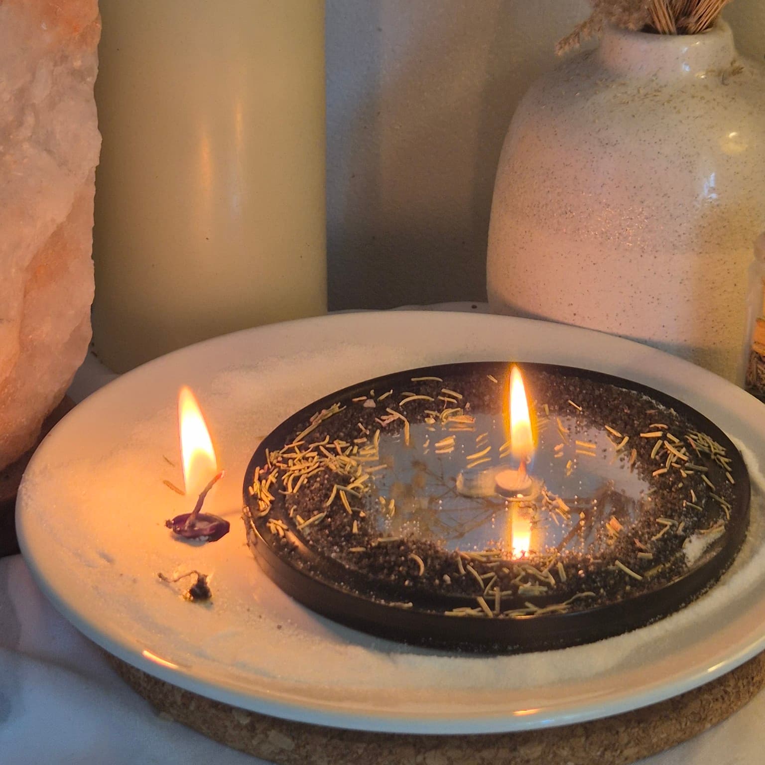 Cord cutting ritual after separation with candles burned down on a fire-resistant plate