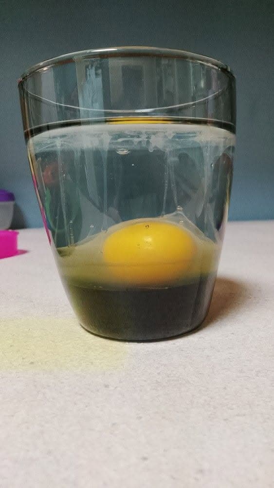 Egg cleanse glass with a dark-looking lower section caused partly by background and lighting